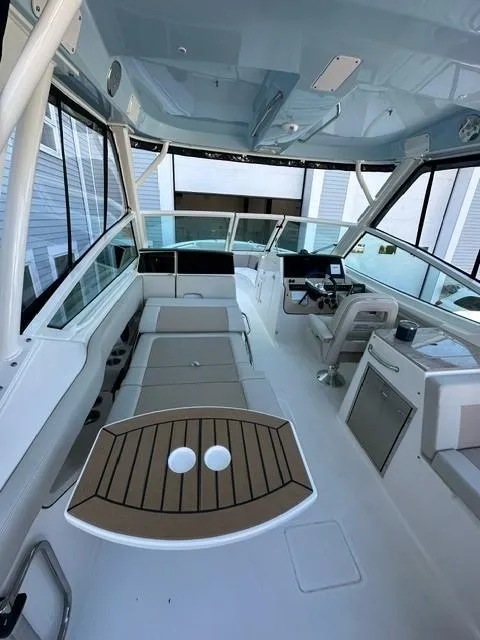 Slide: The Image of 2023 Boston Whaler 280 Vantage boat interior with seating and helm station. - 12