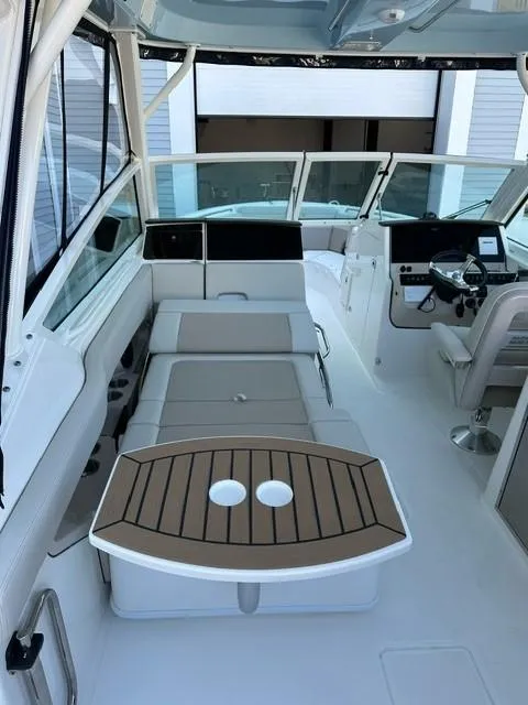 Slide: The Image of 2023 Boston Whaler 280 Vantage boat interior with seating and helm station. - 13