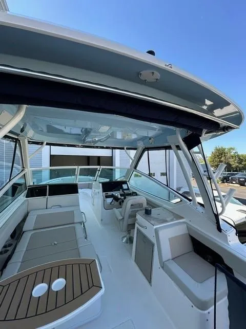 Slide: The Image of 2023 Boston Whaler 280 Vantage boat interior with seating and helm station. - 14