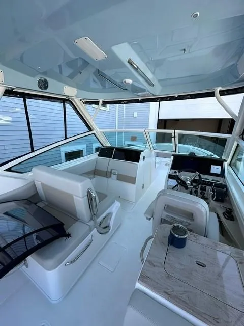 Slide: The Image of 2023 Boston Whaler 280 Vantage boat interior with seating and control console. - 15