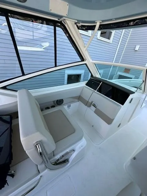 Slide: The Image of 2023 Boston Whaler 280 Vantage boat interior with seating and console. - 16