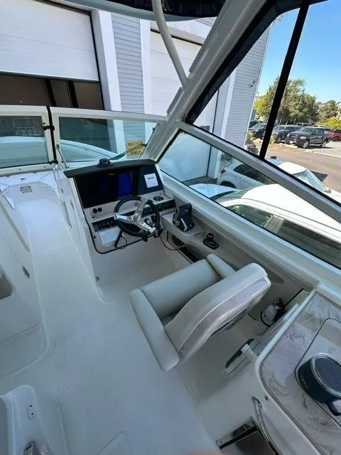 Slide: The Image of 2023 Boston Whaler 280 Vantage helm station with modern controls and comfortable seating. - 17