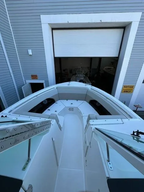 Slide: The Image of 2023 Boston Whaler 280 Vantage boat docked in a marina storage facility. - 18