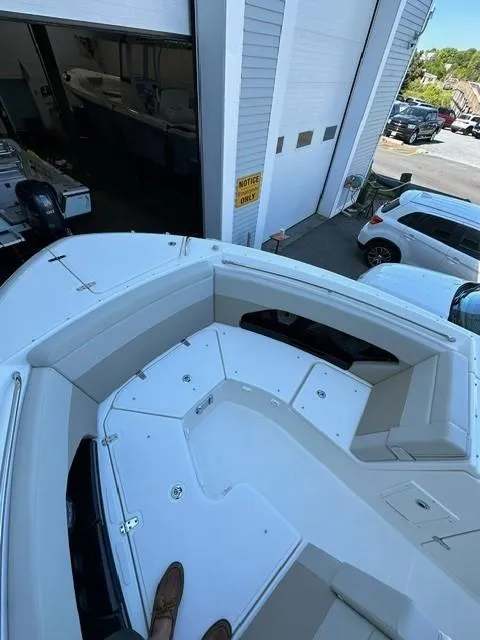 Slide: The Image of 2023 Boston Whaler 280 Vantage boat docked near a garage. - 19