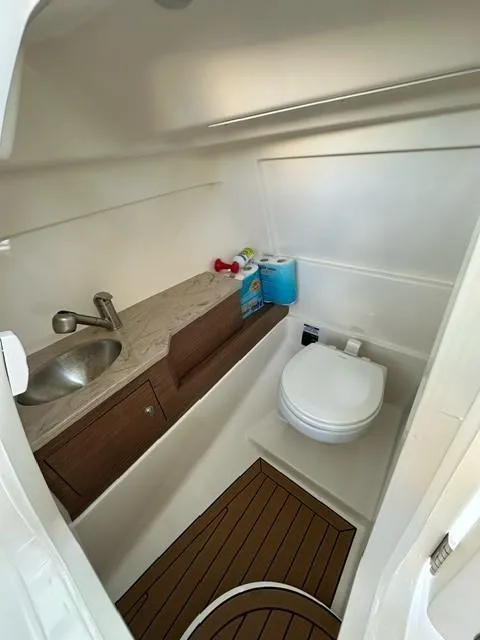 Slide: The Image of 2023 Boston Whaler 280 Vantage boat bathroom with sink and toilet. - 21