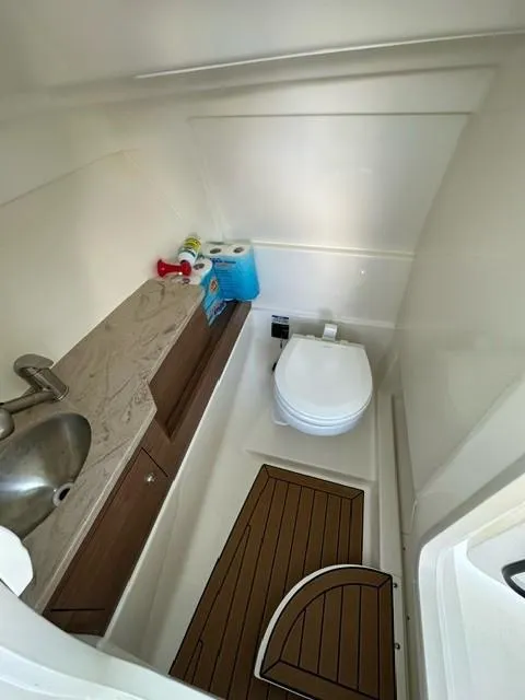 Slide: The Image of 2023 Boston Whaler 280 Vantage boat bathroom with sink, toilet, and storage. - 22