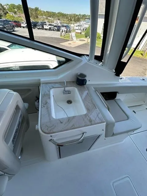 Slide: The Image of 2023 Boston Whaler 280 Vantage boat interior with sink and countertop. - 25