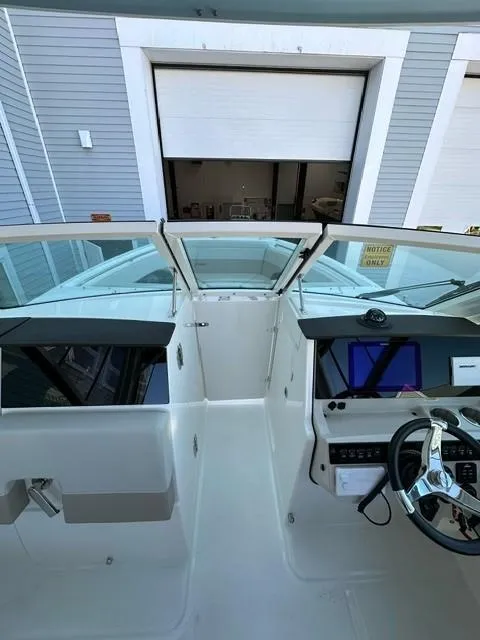 Slide: The Image of 2023 Boston Whaler 280 Vantage boat cockpit with modern controls and steering wheel. - 27