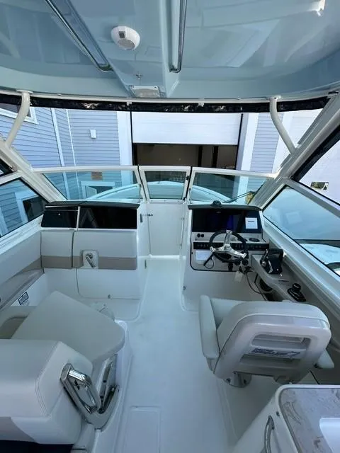 Slide: The Image of 2023 Boston Whaler 280 Vantage boat interior with helm and seating. - 29