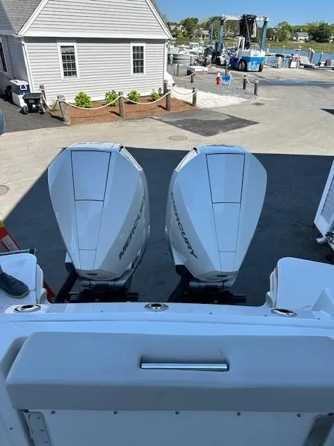 Slide: The Image of 2023 Boston Whaler 280 Vantage with twin Mercury outboard engines at a marina. - 31