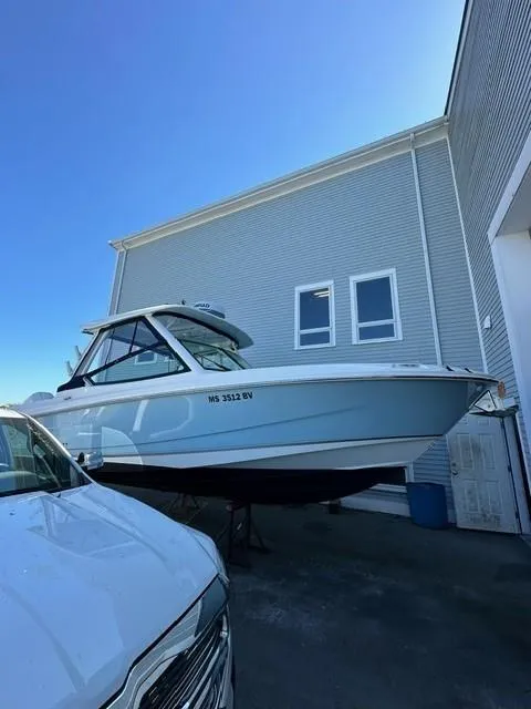 Slide: The Image of 2023 Boston Whaler 280 Vantage boat docked near a building. - 34