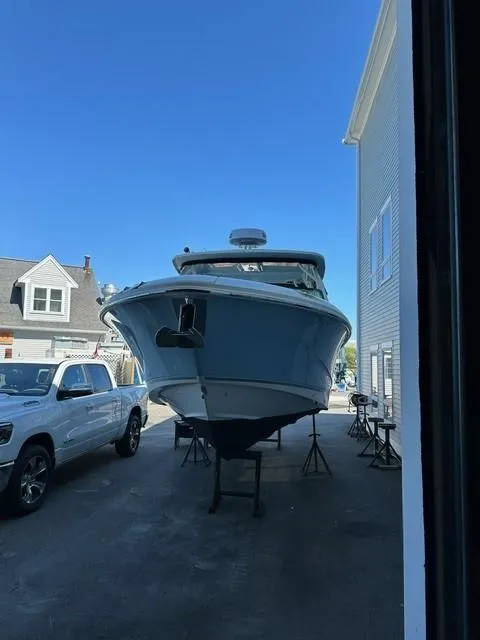 Slide: The Image of 2023 Boston Whaler 280 Vantage boat on stands in a driveway. - 35