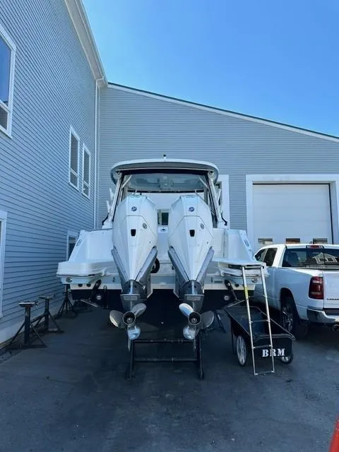 Slide: The Image of 2023 Boston Whaler 280 Vantage boat with dual engines in a marina. - 37