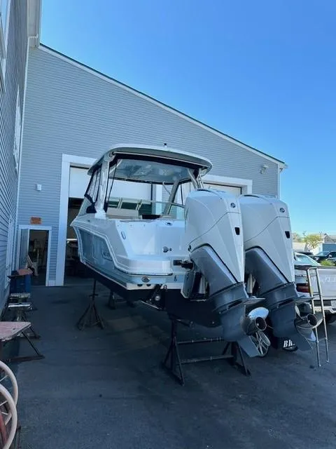 Slide: The Image of 2023 Boston Whaler 280 Vantage boat with dual outboard engines in a marina. - 38