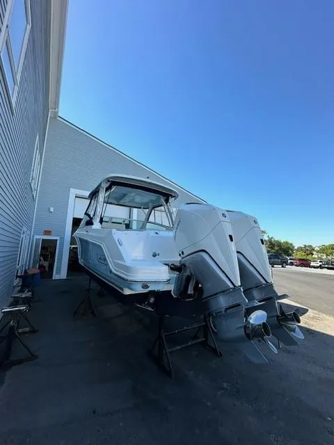 Slide: The Image of 2023 Boston Whaler 280 Vantage boat with dual outboard engines on a trailer. - 39