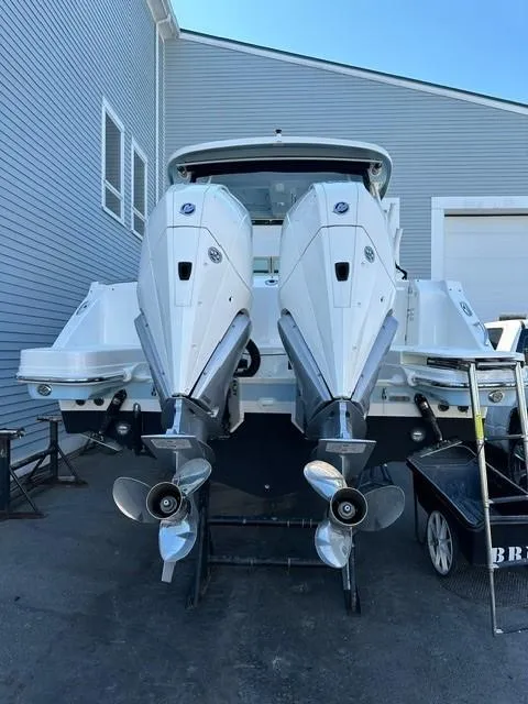 Slide: The Image of 2023 Boston Whaler 280 Vantage with dual outboard engines in a marina. - 6