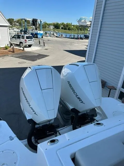 Slide: The Image of 2023 Boston Whaler 280 Vantage with twin Mercury outboard engines at a marina. - 8