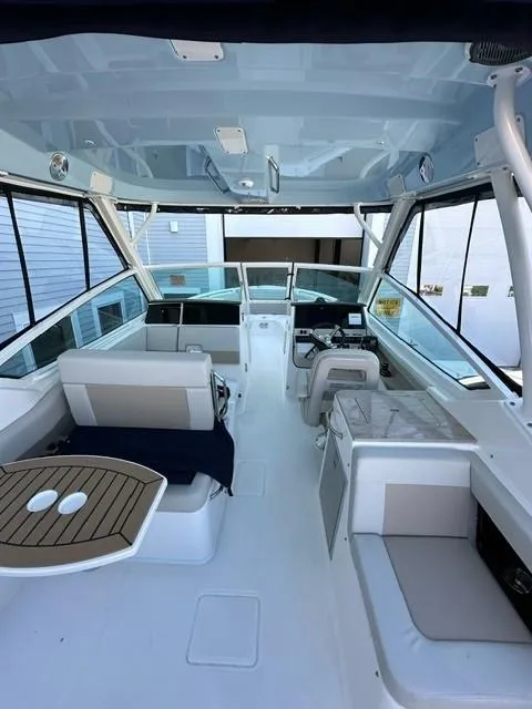 Slide: The Image of 2023 Boston Whaler 280 Vantage boat interior with seating and helm station. - 9