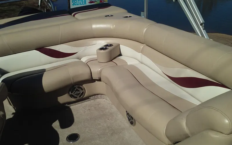 Slide: The Image of 2012 Crest Classic 210 boat interior with beige and maroon seating. - 10
