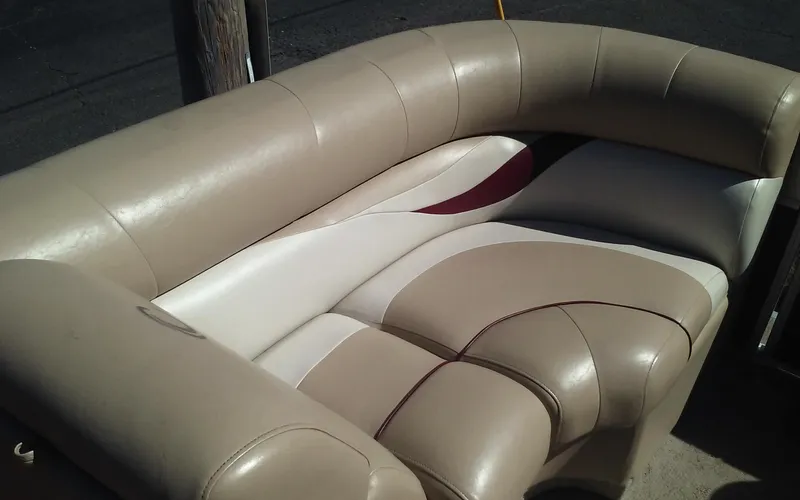 Slide: The Image of 2012 Crest Classic 210 boat seating with beige and white upholstery. - 12