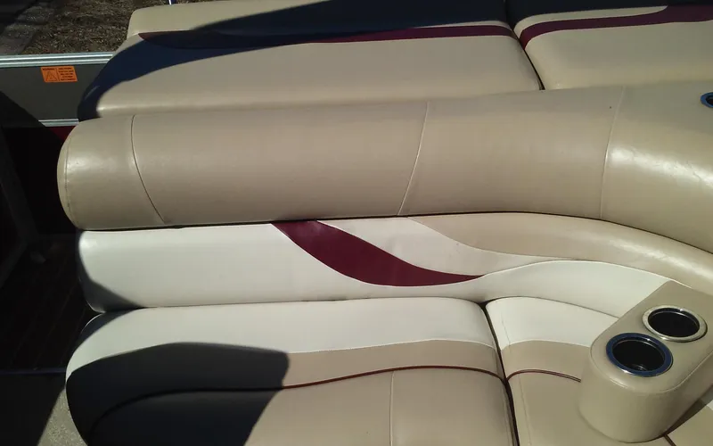Slide: The Image of 2012 Crest Classic 210 boat interior with beige and maroon seating. - 13