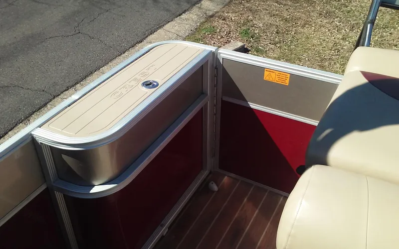 Slide: The Image of Interior of 2012 Crest Classic 210 pontoon boat with red and beige accents. - 14