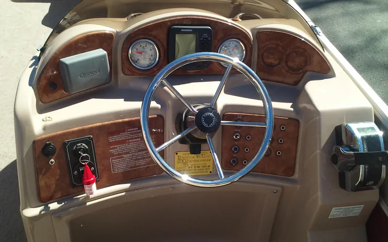 Slide: The Image of 2012 Crest Classic 210 boat dashboard with steering wheel and control panel. - 16