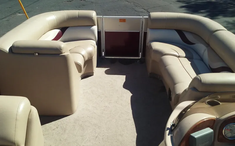 Slide: The Image of 2012 Crest Classic 210 pontoon boat with beige seating and spacious deck. - 19