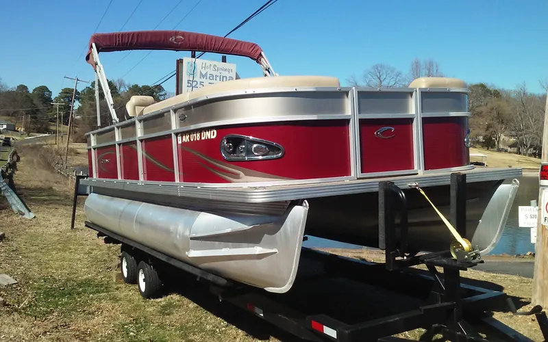 Slide: The Image of 2012 Crest Classic 210 pontoon boat on trailer, red and silver exterior. - 2