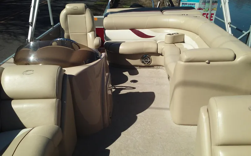 Slide: The Image of Interior of a 2012 Crest Classic 210 pontoon boat with beige seating. - 20