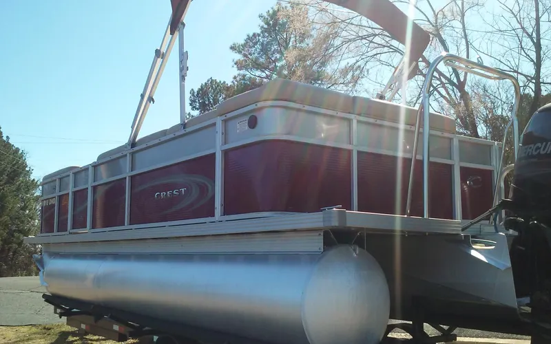 Slide: The Image of 2012 Crest Classic 210 pontoon boat with red and silver design. - 5