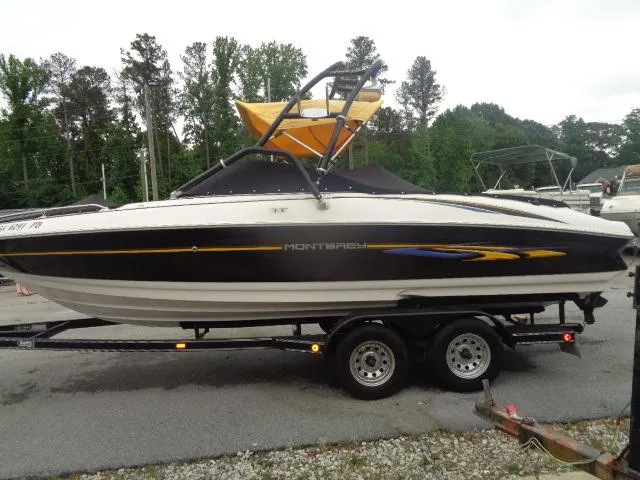 Slide: The Image of 2001 Monterey 218LS Montura boat on a trailer in a parking lot. - 4