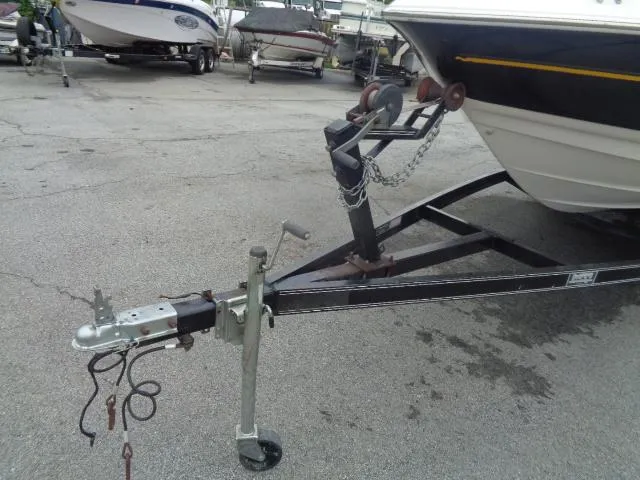 Slide: The Image of 2001 Monterey 218LS Montura boat on a trailer in a parking lot. - 7