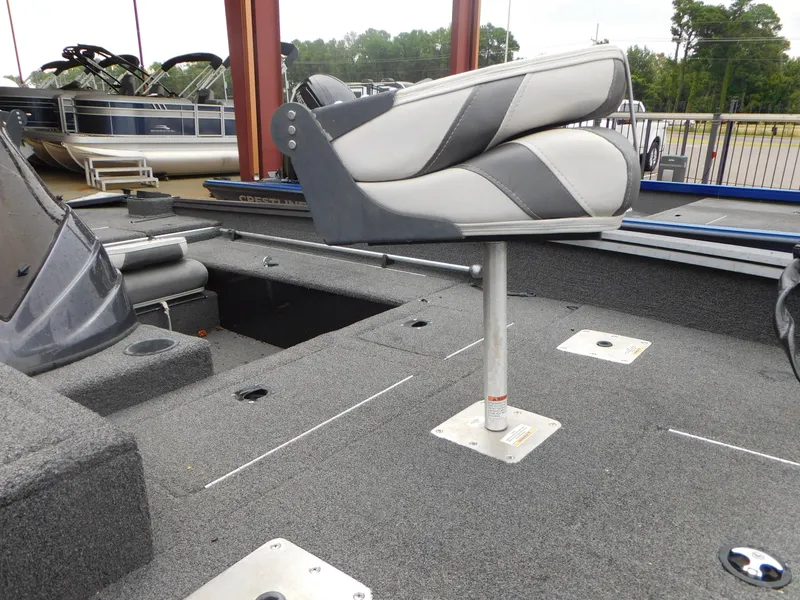 Slide: The Image of 2018 Polar Kraft 175TX Pro boat interior with swivel seat and carpeted deck. - 2