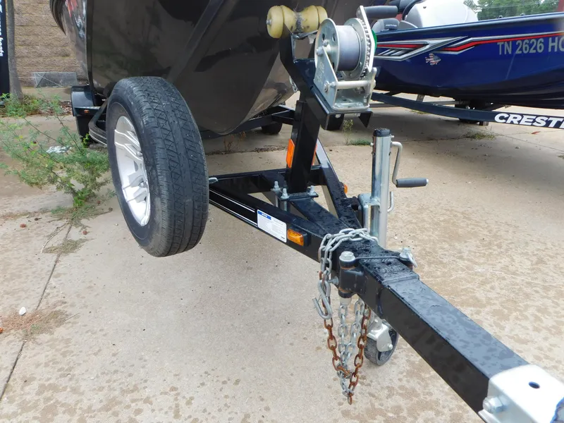 Slide: The Image of 2018 Polar Kraft 175TX Pro boat trailer with winch and chains on concrete surface. - 9