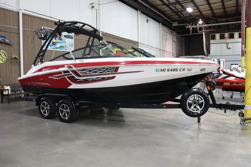 Slide: The Image of 2017 Regal 2000 ESX Bowrider boat on trailer in indoor storage facility. - 1