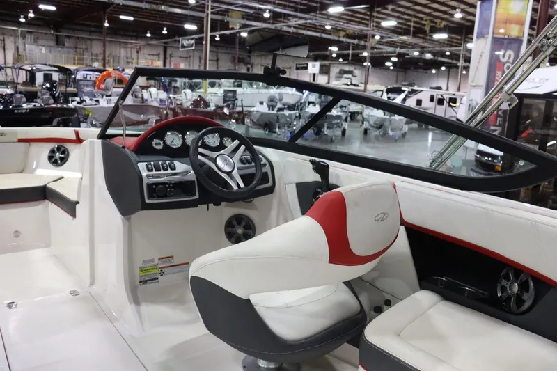Slide: The Image of 2017 Regal 2000 ESX Bowrider interior with white and red seating, steering wheel, and dashboard. - 6