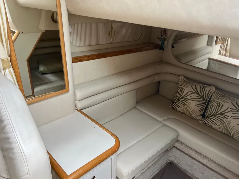 Slide: The Image of 1997 Sea Ray 330 Sundancer cabin interior with beige seating and decorative pillows. - 12