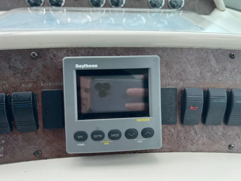 Slide: The Image of Raytheon display and controls on 1997 Sea Ray 330 Sundancer dashboard. - 15