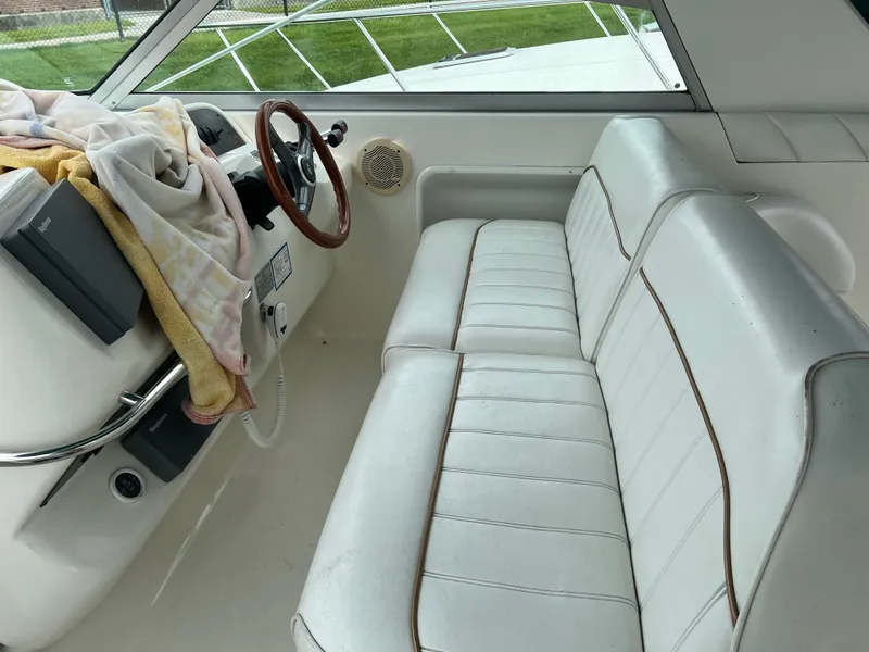 Slide: The Image of Interior of 1997 Sea Ray 330 Sundancer with white leather seating and steering wheel. - 2