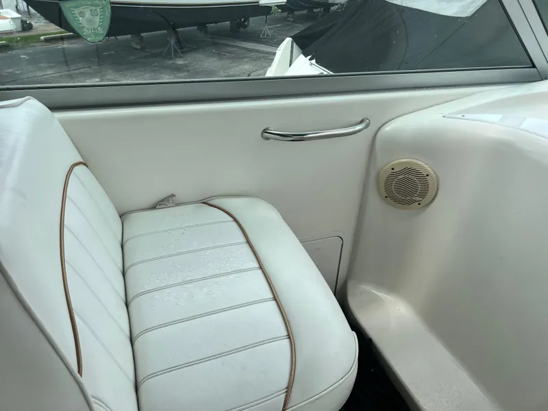 Slide: The Image of Interior seating of a 1997 Sea Ray 330 Sundancer boat with white upholstery. - 4