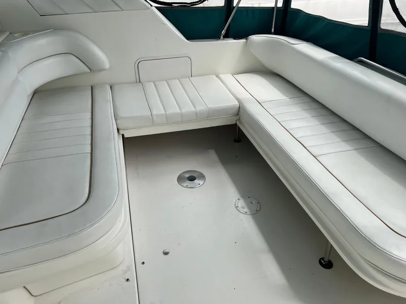 Slide: The Image of 1997 Sea Ray 330 Sundancer interior seating area with white leather upholstery. - 7