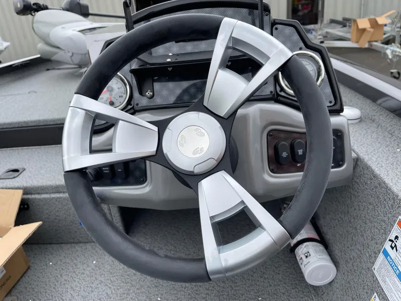 Slide: The Image of Steering wheel of 2024 G3 Sportsman 1810 PFX boat with dashboard controls. - 3