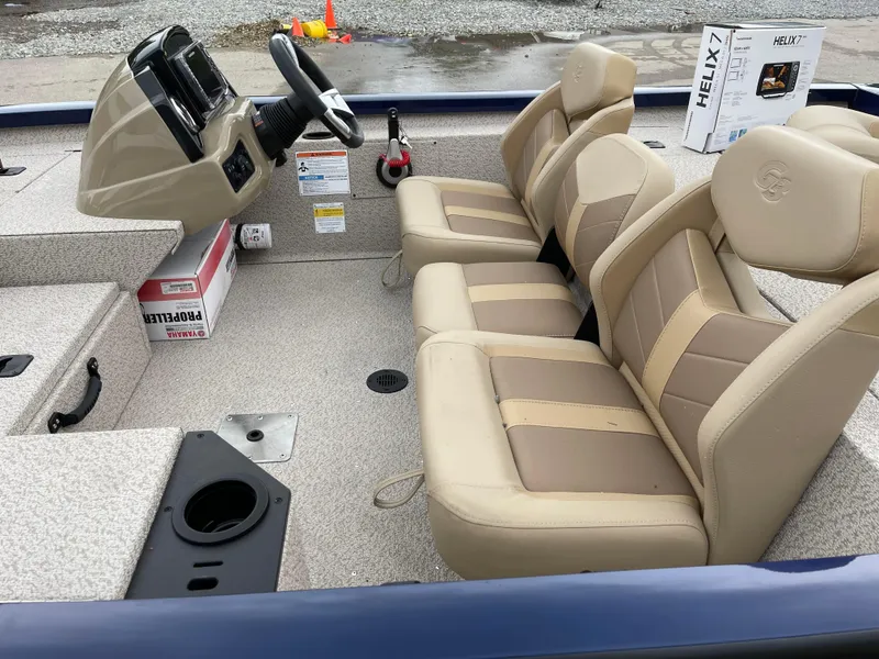 Slide: The Image of 2024 G3 Sportsman 1810 PFX boat interior with beige seats and steering console. - 11