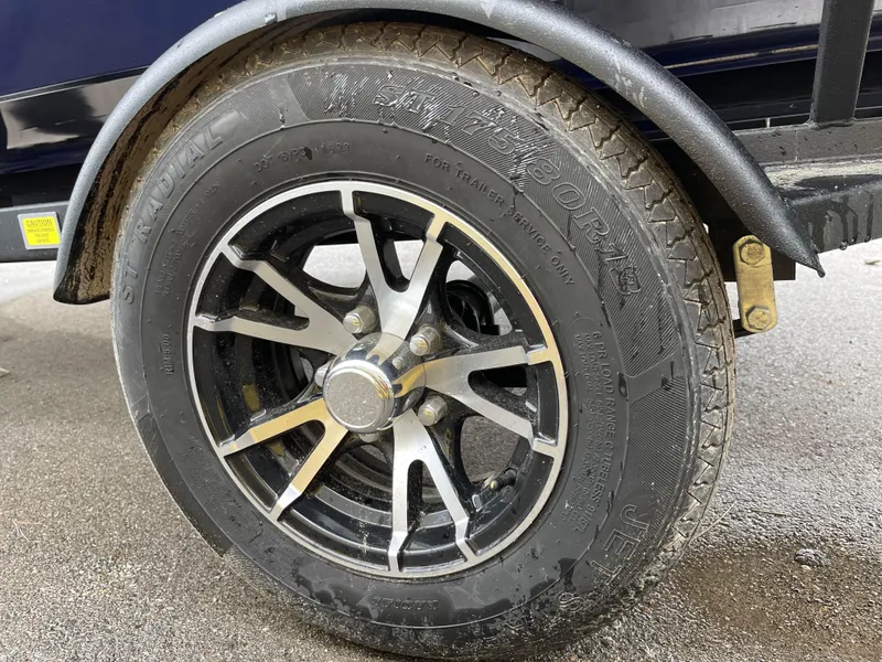 Slide: The Image of Close-up of a 2024 G3 Sportsman 1810 PFX trailer wheel and tire. - 12