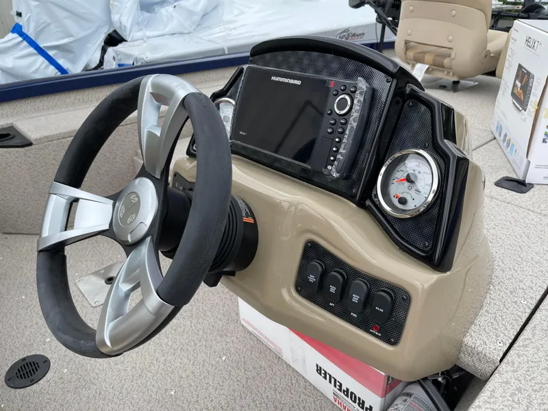 Slide: The Image of 2024 G3 Sportsman 1810 PFX boat dashboard with steering wheel and navigation system. - 3