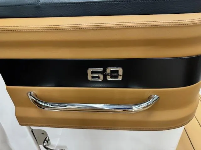 Slide: The Image of 2025 Chaparral 250 OSX interior detail with chrome handle and number 69. - 10