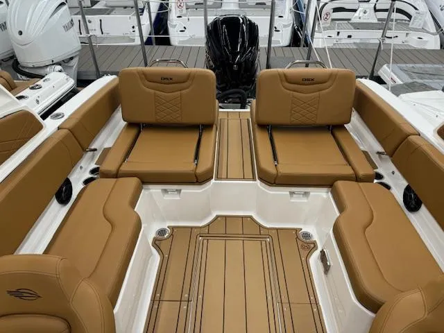 Slide: The Image of 2025 Chaparral 250 OSX boat interior with tan leather seating and sleek design. - 12