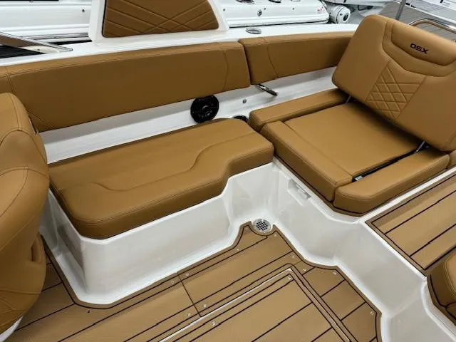 Slide: The Image of 2025 Chaparral 250 OSX boat interior with tan leather seating and white accents. - 13