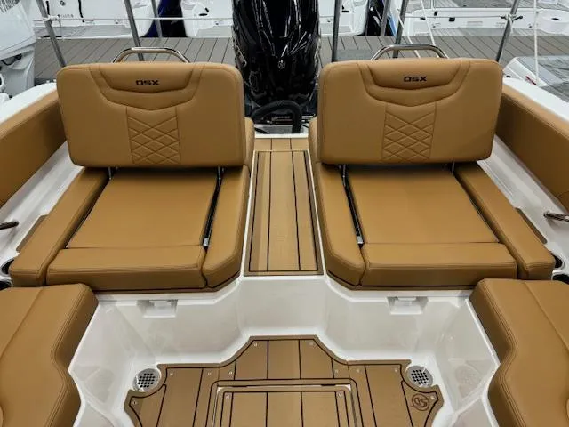 Slide: The Image of 2025 Chaparral 250 OSX boat interior with tan leather seating and sleek design. - 14